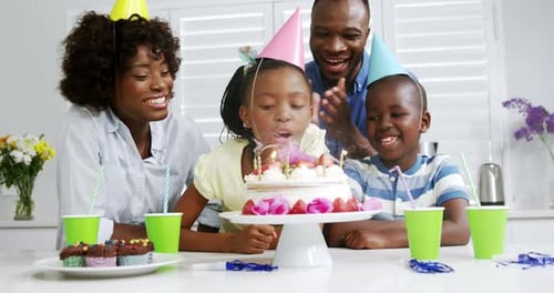 Family Celebrates Birthday with Cake and Candles