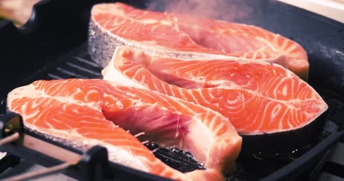 Salmon Steaks Cooking in a Pan Close Up