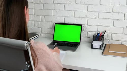 Woman Working at Laptop with Green Screen
