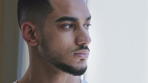 Young Man Looking Out Window Close Up