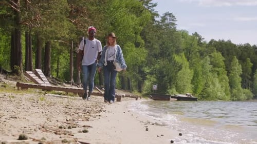 Friends Walking Along Lake Shore