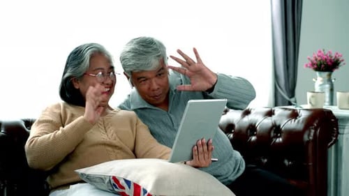 Elderly Asian Using Modern Gadgets