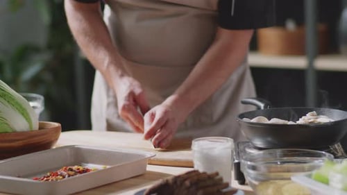 Man Tossing and Frying Veggies and Mushrooms on Skillet
