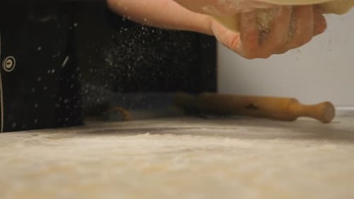 Male Arms of Cook Forming Pastry on a Wooden Surface at Restaurant