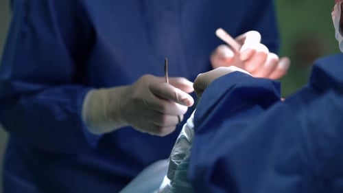 Surgeons Perform Operation Using Medical Tools