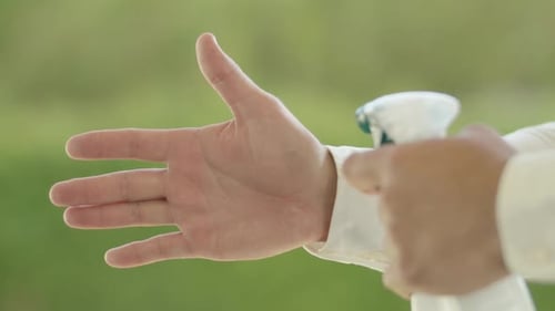 Hand Being Sprayed With Sanitizer in Close Up