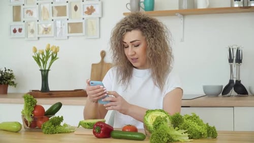 Woman Taking Photos of Vegetables in Kitchen