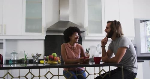 Couple Chatting at Kitchen Counter
