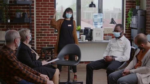 Diverse Team Meeting with Masks in Modern Office