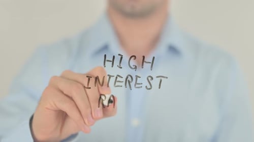 Man Writes 'High Interest Rates' on Glass