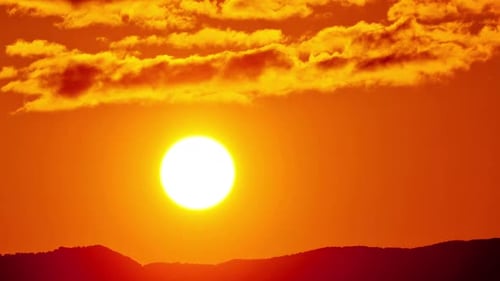 Radiant Sunrise Over Dark Mountain Silhouette