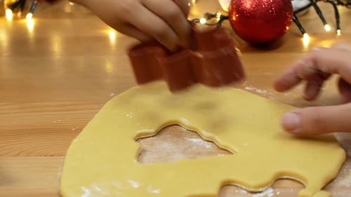 Child and Adult Making Christmas Cookies Together