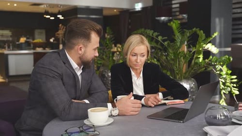 Business Colleagues Meeting at a Table with Laptop