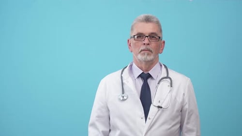 Mature Doctor Points to the Left