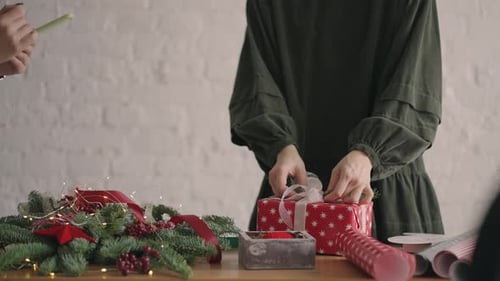 Decorating Christmas Presents with Greenery and Berries