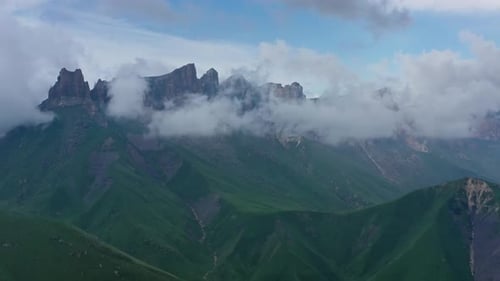 Scenic Aerial View of Green Mountains and Clouds
