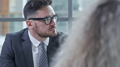 Businessman Smiling and Talking during Meeting
