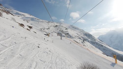 Winter Panorama with Ski Lifts and Snow Covered Mountains on a Sunny Day.