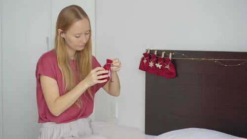 Woman Putting Gift in Christmas Bag