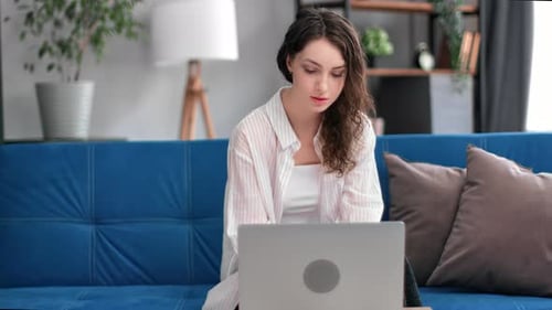 Confident Beautiful Freelancer Business Woman Working Remotely at Home Office Use Laptop Pc on Couch