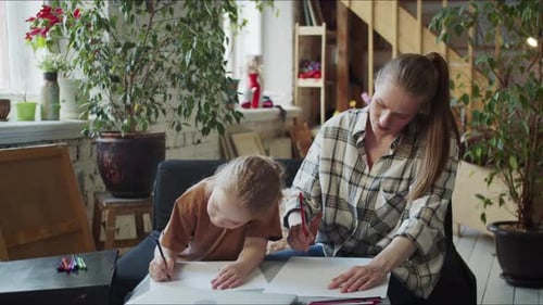 Mother and Child Drawing Pictures Together Indoors
