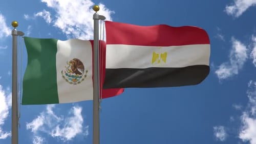 Mexico and Egypt National Flags Waving Against Blue Sky