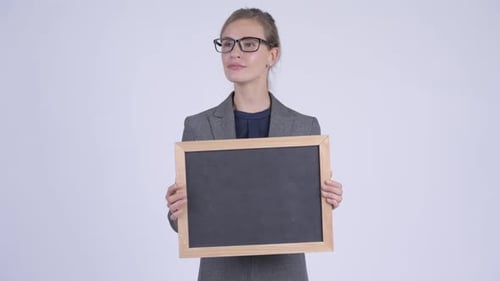 Businesswoman Holds Blank Chalkboard Sign Smiling