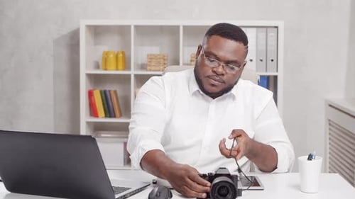 Workplace of freelance worker at home office. Young African-American man.