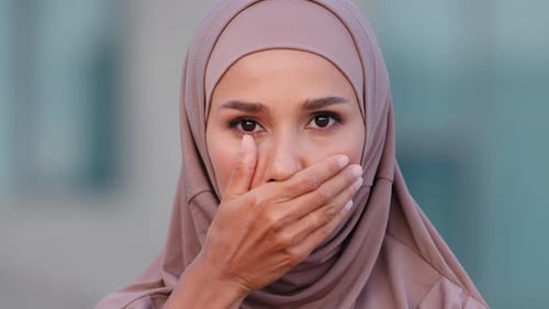 Young Woman Covering Mouth Wearing Hijab Close Up
