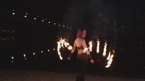 Woman Performing Fire Dancing at Night