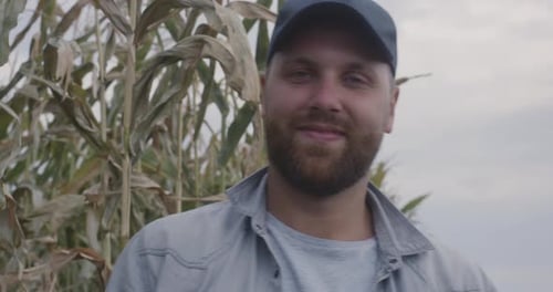 Cheerful Farmer in Corn Field