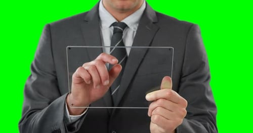 Man in Suit Using Clear Tablet on Greenscreen