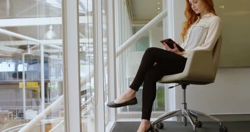 Female executive using digital tablet in office 4k