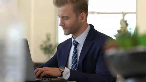 MS of businessman happiness at desk with laptop in lobby space office background