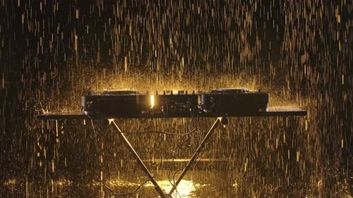 Professional Mixer Console for Playing Dance Music in a Dark Studio with Stage Lighting. Drops of