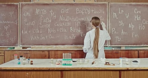 A Young Beautiful Female Scientist Works in a Classroom Teaching Laboratory
