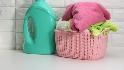 Bright Laundry Detergent and Colorful Towels Close Up