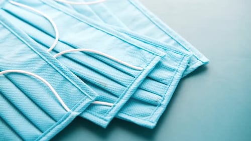 Close Up of Blue Surgical Masks on Table