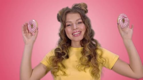 Woman with Space Buns Posing with Donuts