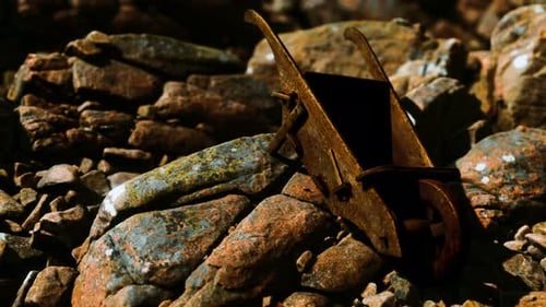 Abandoned Wooden Mine Wheelbarrow on Rocks
