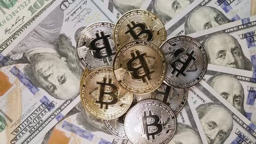 Golden and silver bitcoins, rotating top view