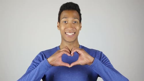 Man Making Heart Shape with Hands Smiling