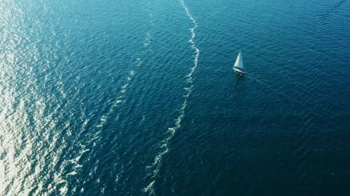 Small Yacht Sails on Blue Water of Adriatic Sea on Sunny Day