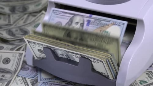 Currency Counter Counting Stacks of One Hundred Dollar Bills
