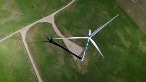 Aerial View of Wind Turbine Rotating in Field