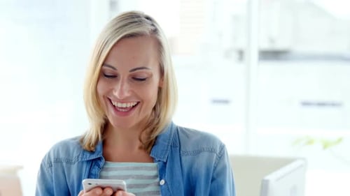 Smiling Woman Using Smartphone Indoors