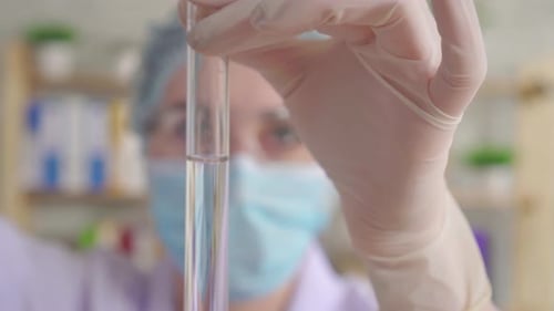 Medical Worker Examining Test Tube in Hospital Lab