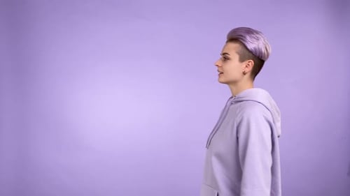 Woman with Purple Hair Waving on Purple Background
