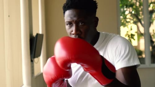 Man Training Boxing with Red Gloves