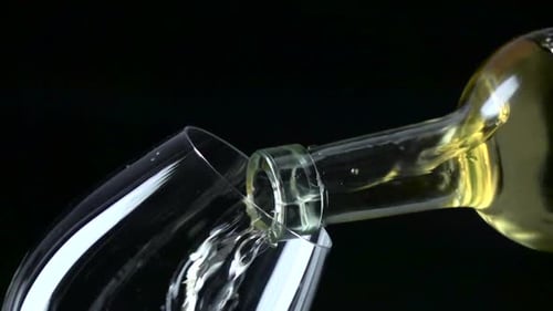 White Wine Flowing into Glass Close Up